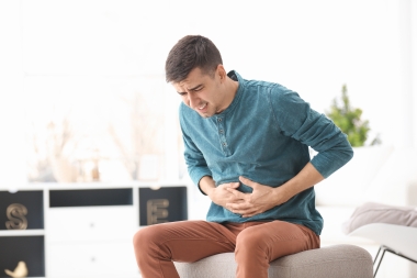 man showing signs of stomach pain