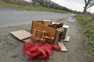 discarded household items lying at side of road